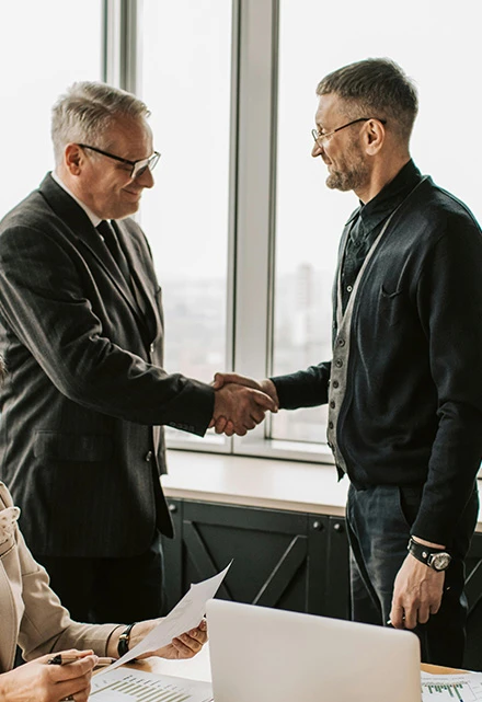 2 men shaking hands after legal funding approval
