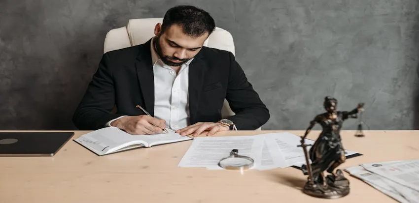 image of an attorney writing while considering attorney funding