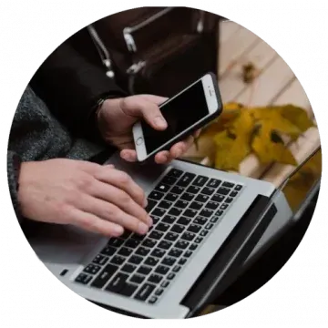 Hands using laptop and phone to apply for legal funding online