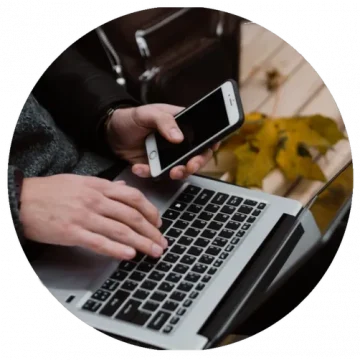 Hands using laptop and phone to apply for legal funding online